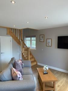a person laying on a couch in a living room at River cottage in Fort William