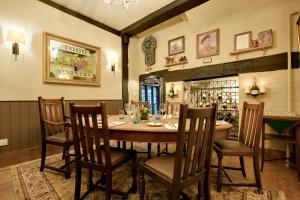 a dining room with a wooden table and chairs at The George Hotel & Brasserie, Cranbrook in Cranbrook +27 photos
