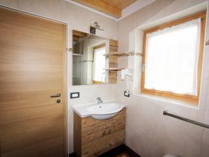 a bathroom with a sink and a mirror and a window at Villa Hilde in San Cassiano +37 photos