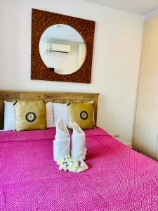 a hotel room with a pink bed with two pillows at Baan Marakesh Hua Hin in Hua Hin