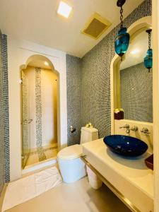 a bathroom with a blue sink and a toilet at Baan Marakesh Hua Hin in Hua Hin