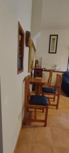 a dining room with a table and chairs with a laptop at CASA DE LOS ABUELOS in Ortigosa del Monte