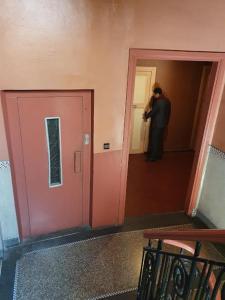 a man standing in a hallway taking a picture at HOTEL DU LOUVRE in Casablanca +5 photos