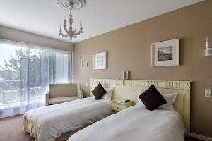 Postel nebo postele na pokoji v ubytování Hotel du Parc