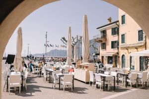 a group of tables and chairs with umbrellas at Casa Cavour Garda in Garda