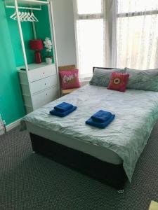 a bedroom with a bed with two blue towels on it at Yado Hotel in Blackpool