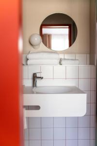 a bathroom with a sink and a mirror at Hôtel Ô Rouge Gevrey-Chambertin - Teritoria in Gevrey-Chambertin