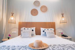 a bedroom with a bed with a hat on it at Ekati Mare Boutique Resort in Kavos