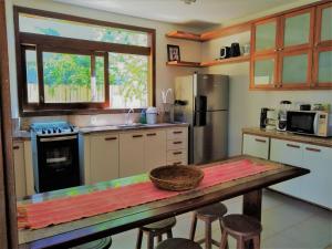 una cocina con una mesa con una cesta. en Casa Sapoti - 5 minutos a pé da praia, en Praia do Forte