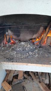 a grill with a fire in the middle of it at Tea in Povljana