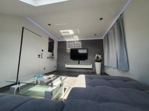 sala de estar con cama y mesa de cristal en New York City Apartment en Paderborn