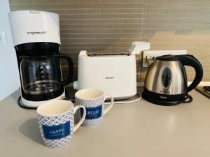 a counter with two coffee makers and two coffee mugs at Casa Lavanda in Torri del Benaco