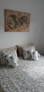 1 cama con 2 almohadas y un mapa en la pared en Habitacion Puerto Rico, en Puerto Rico de Gran Canaria