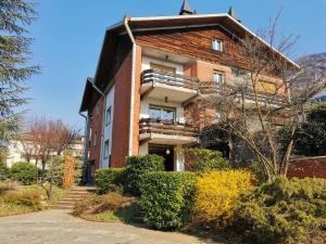 a large brick building with a balcony on it at La Casa Del Quirino in Tirano