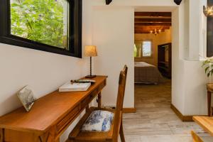 a home office with a wooden desk and a window at Tu Apart En Bariloche 16 in San Carlos de Bariloche