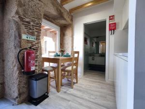 una cucina e una sala da pranzo con tavolo e estintore di Cantinho do Sossego a Vila Nova de Cerveira