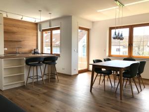 a kitchen and dining room with a table and chairs at Obst- und Ferienhof Fahr in Friedrichshafen
