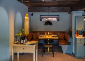 a dining room with a table and a couch at Eibsee Hotel in Grainau