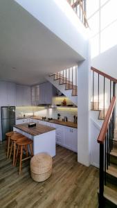 a kitchen with white cabinets and a table and chairs at Casa Terra in Batu