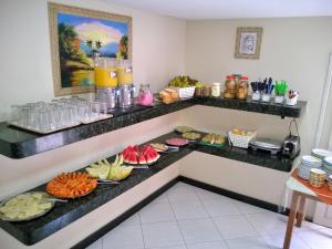 a buffet in a hotel room with plates of food at Pousada Panorâmica in Aracaju