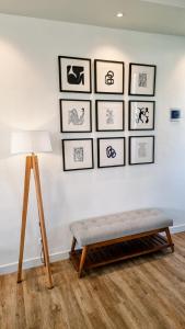 a room with a bench and a wall with pictures at Casa Terra in Batu