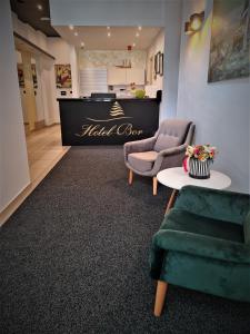 a waiting room with two chairs and a table at Hotel Bor in Krk