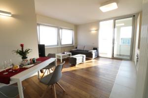 sala de estar con mesa, sillas y sofá en Aparthotel Isola, en Milán