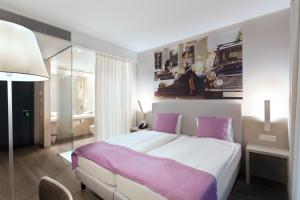 Postel nebo postele na pokoji v ubytování Hotel City Lugano