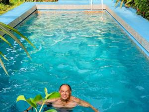 a man in a swimming pool at Villa Bobo in Bobo-Dioulasso