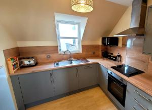 a kitchen with a sink and a window at Comfortable flat in Fort William in Fort William