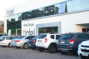a row of parked cars in front of a store at Brisa Parque Hotel in Erechim