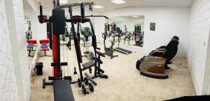 a gym with several tread machines in a room at Pensjonat Pod Kogutami in Bieliny