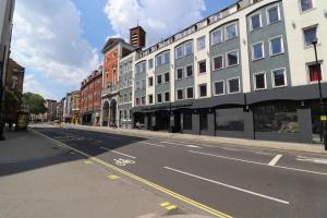 an empty street in a city with buildings at The Bryson Hotel in London