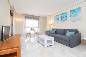 a living room with a couch and a table at Marjeleta Apartamento in Moraira