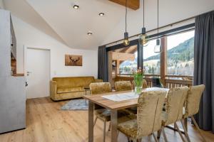 a kitchen and dining room with a table and chairs at My Dahoam in Eben im Pongau