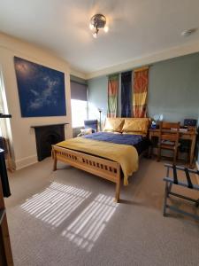 1 dormitorio con 1 cama grande y chimenea en Alma House Bed and Breakfast en Newbury