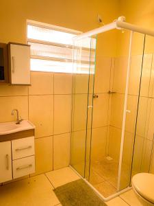 a bathroom with a shower and a toilet at Aconchego in Amparo
