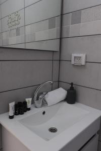 a bathroom sink with cups and a faucet at Oriental Nature in Majdal Shams
