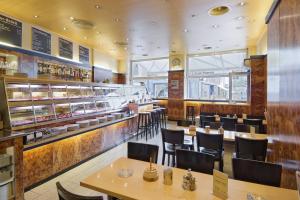 a restaurant with tables and chairs and a counter at Stadthof Budget Hotel Basel City Center in Basel