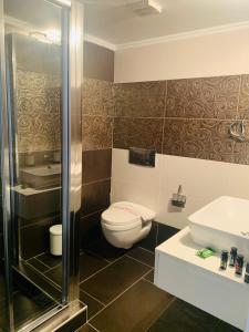 a bathroom with a toilet and a sink at Elegant Apartment Keramoti in Keramoti +43 photos