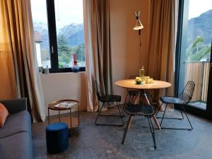 a living room with a table and chairs in front of a window at Picobello Lago in Mandello del Lario