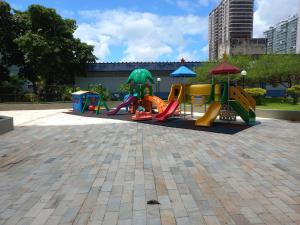 a playground with slides and play equipment in a park at SEU CANTINHO NA BARRA in Rio de Janeiro