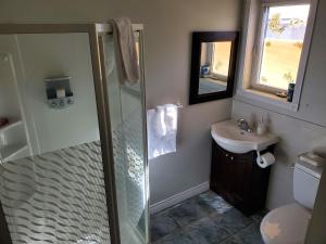 a bathroom with a shower and a sink at Sonora Desert Inn in Osoyoos +60 photos