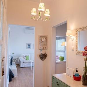 a hallway with a living room and a chandelier at Alemar Estates Agia Triada in Agia Triada +24 photos