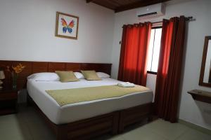 Postel nebo postele na pokoji v ubytování Hostal Macambo
