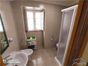 a bathroom with a toilet and a shower at Casa Pepa in Corcubión