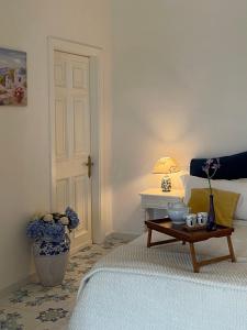 a bedroom with a bed and a table with a lamp at Villa Neptunus in Ischia
