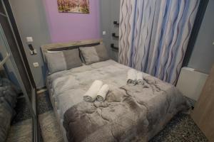 a small bedroom with a bed with slippers on it at Efis guest house near Nafpaktos-Fully Equipped Home in Nafpaktos