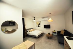 a bedroom with a bed and a sink and a mirror at סוויטת רויאל שירה in Eilat