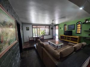 a living room with a couch and a table at Rock n Hostel in Cabo Frio